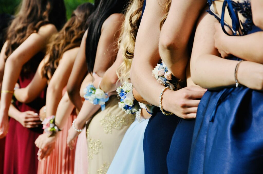Woman in a blue sleeveless dress and floral tiara on prom day