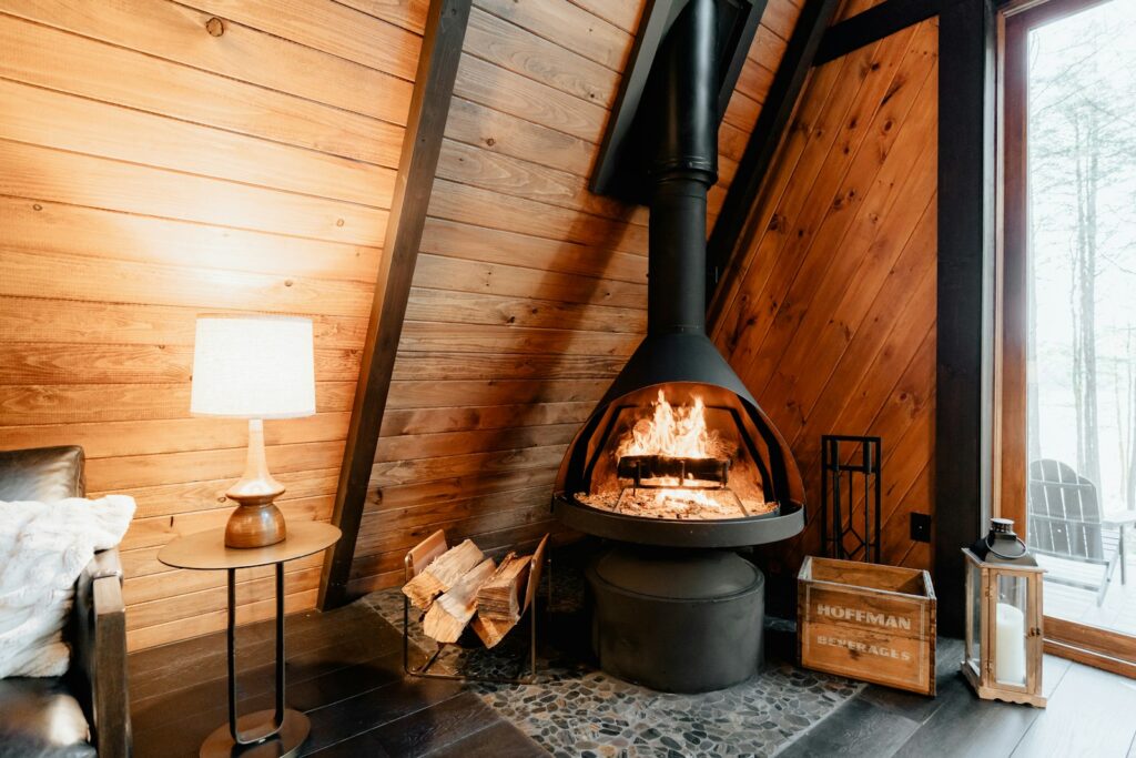 Wood burning stove inside a wooden cabin, a cosy setting for a winter break