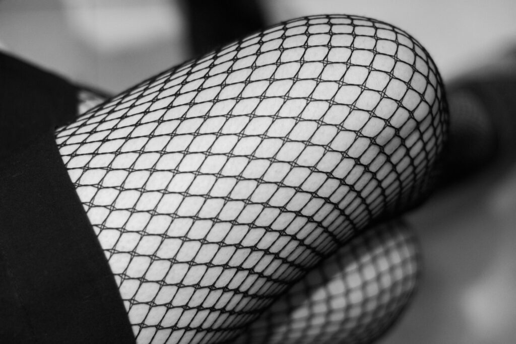 Close-up of a person wearing fishnet stockings, showing how the style looks when worn