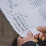 Close-up of a person holding a piece of paper, as when reviewing estate documents